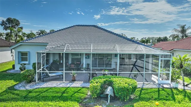 a view of a house with backyard and porch