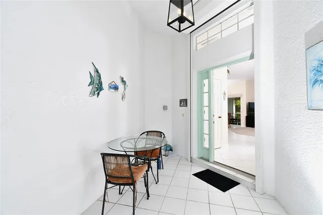 a view of a dining room with furniture and chandelier