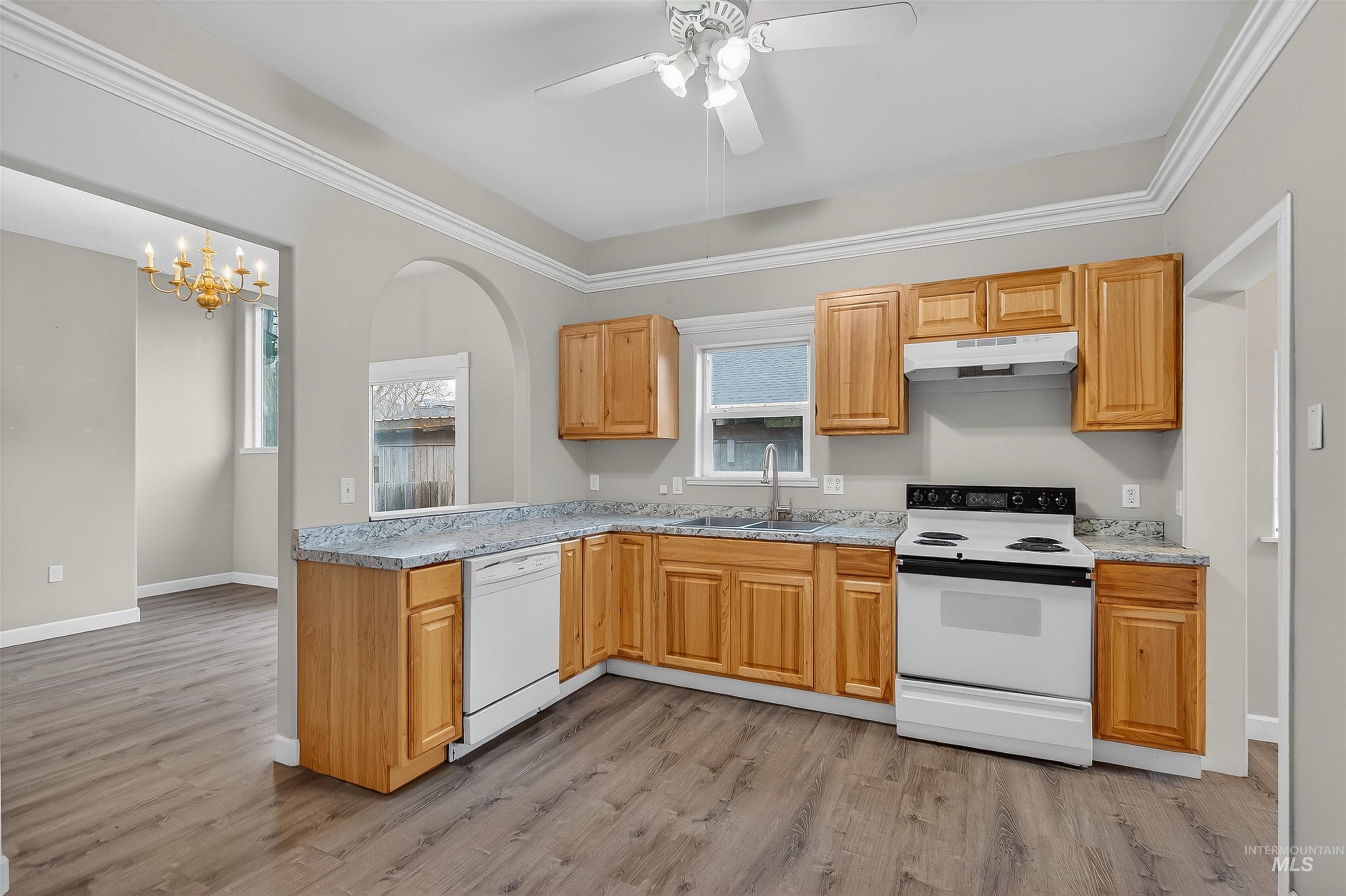 833 8th Street Clarkston, WA 99403 - Photo 11 of 40 Kitchen featuring white appliances, light countertops, a chandelier, and light wood-style floors