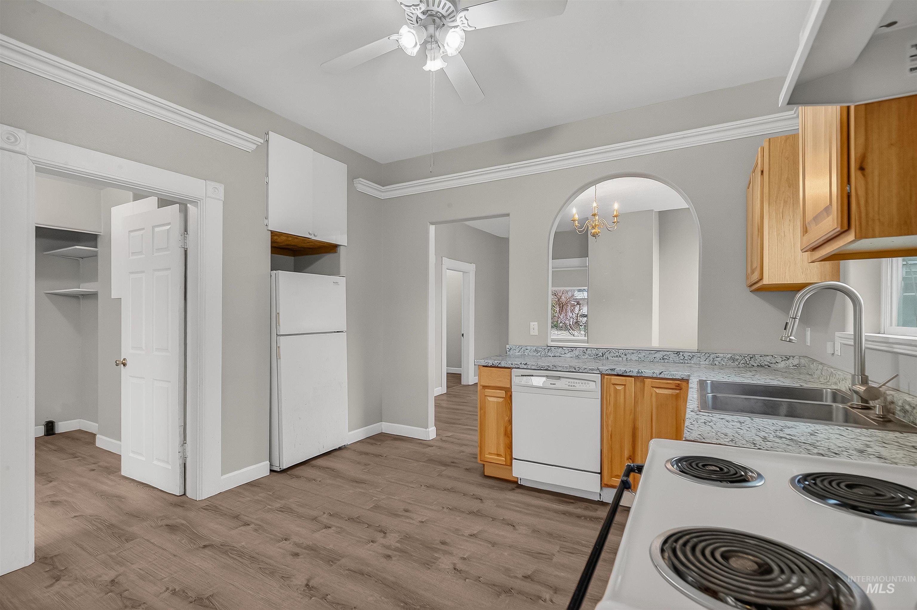 833 8th Street Clarkston, WA 99403 - Photo 14 of 40 Kitchen featuring light countertops, white appliances, ceiling fan, a chandelier, and light wood finished floors
