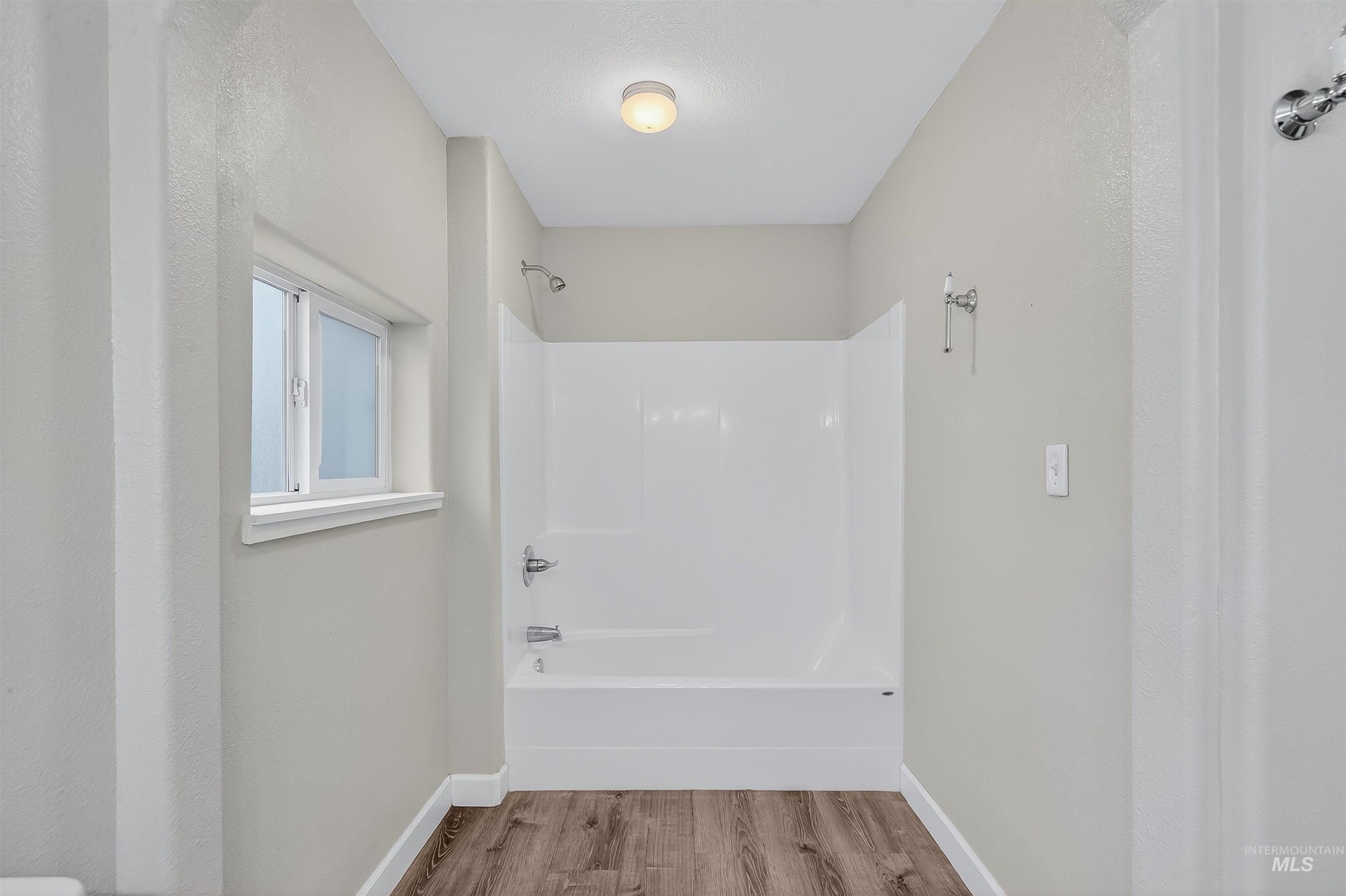 833 8th Street Clarkston, WA 99403 - Photo 19 of 40 Full bathroom with shower / bath combo and wood finished floors