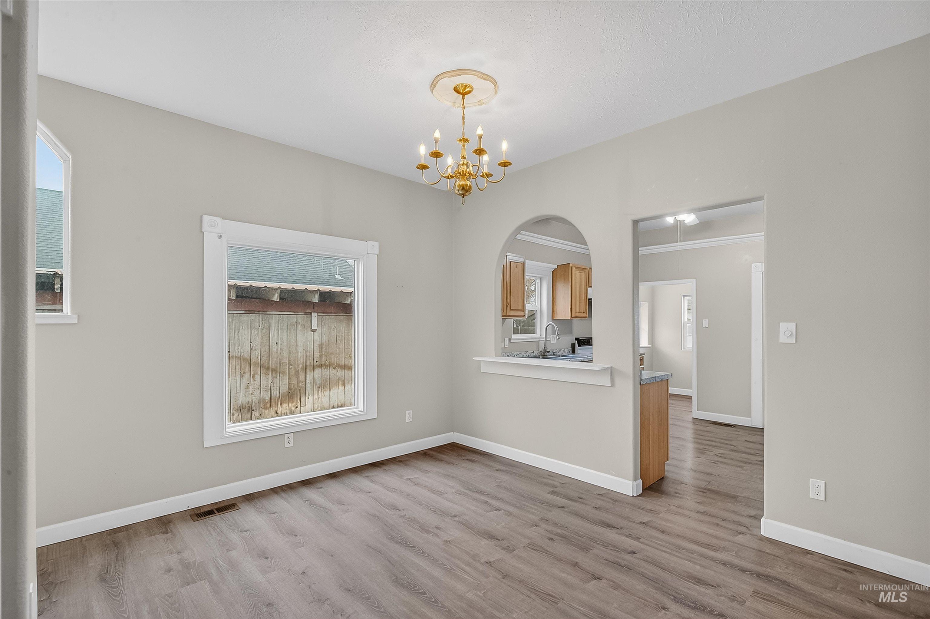 833 8th Street Clarkston, WA 99403 - Photo 6 of 40 Unfurnished dining area with light wood finished floors and a chandelier