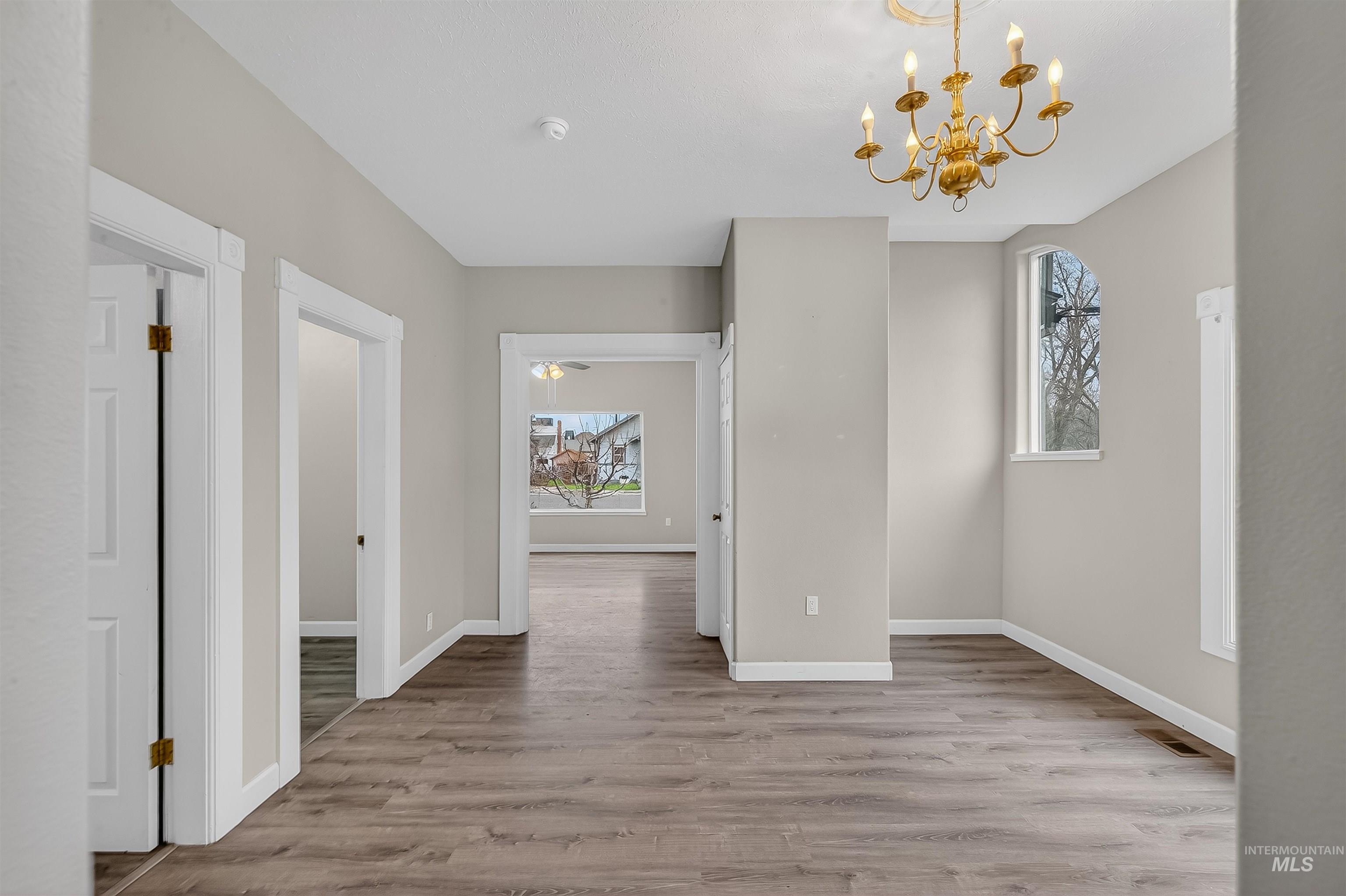 833 8th Street Clarkston, WA 99403 - Photo 8 of 40 Unfurnished dining area with light wood-style flooring and a chandelier