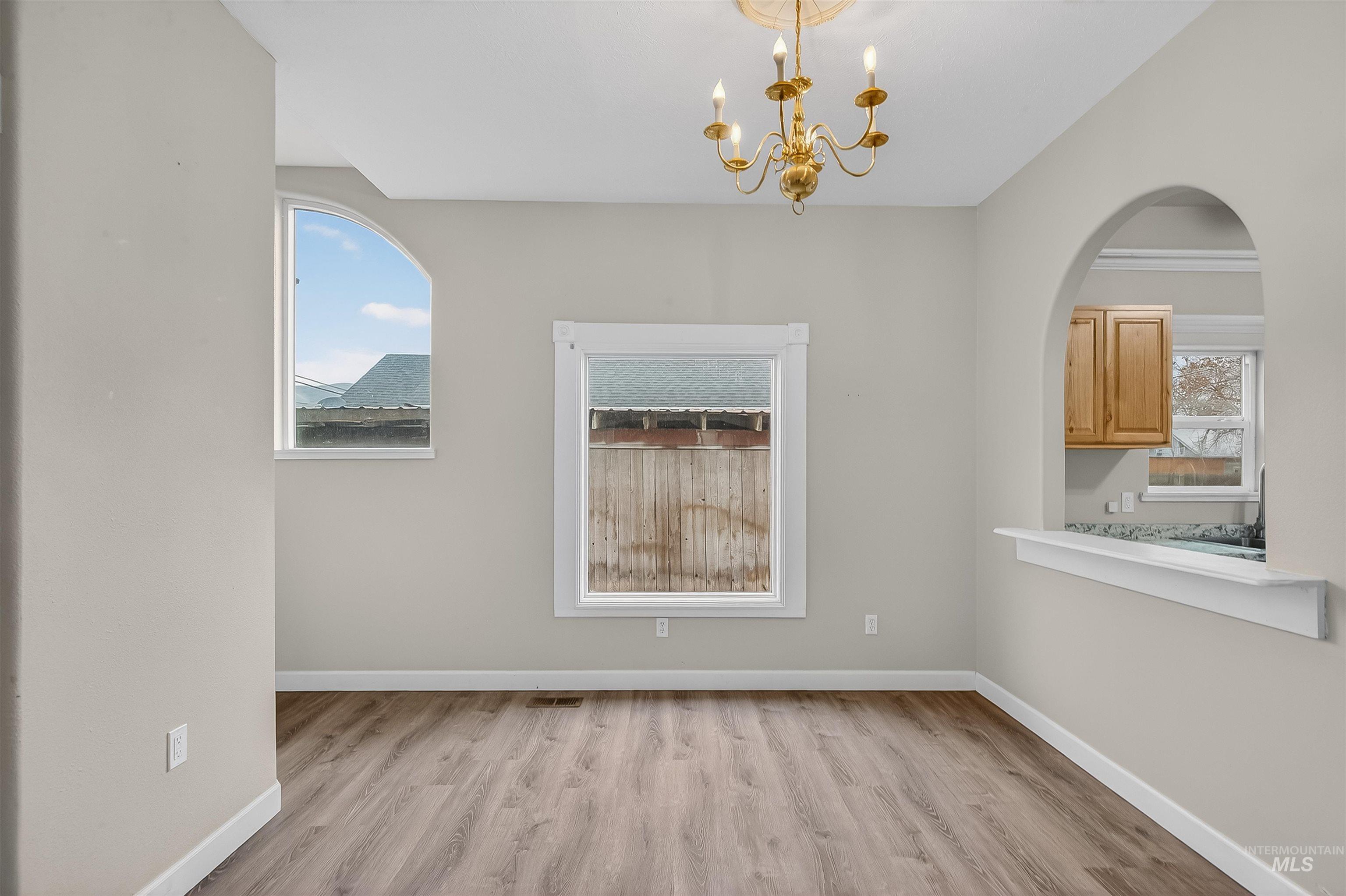 833 8th Street Clarkston, WA 99403 - Photo 10 of 40 Unfurnished dining area with light wood-style flooring and a chandelier