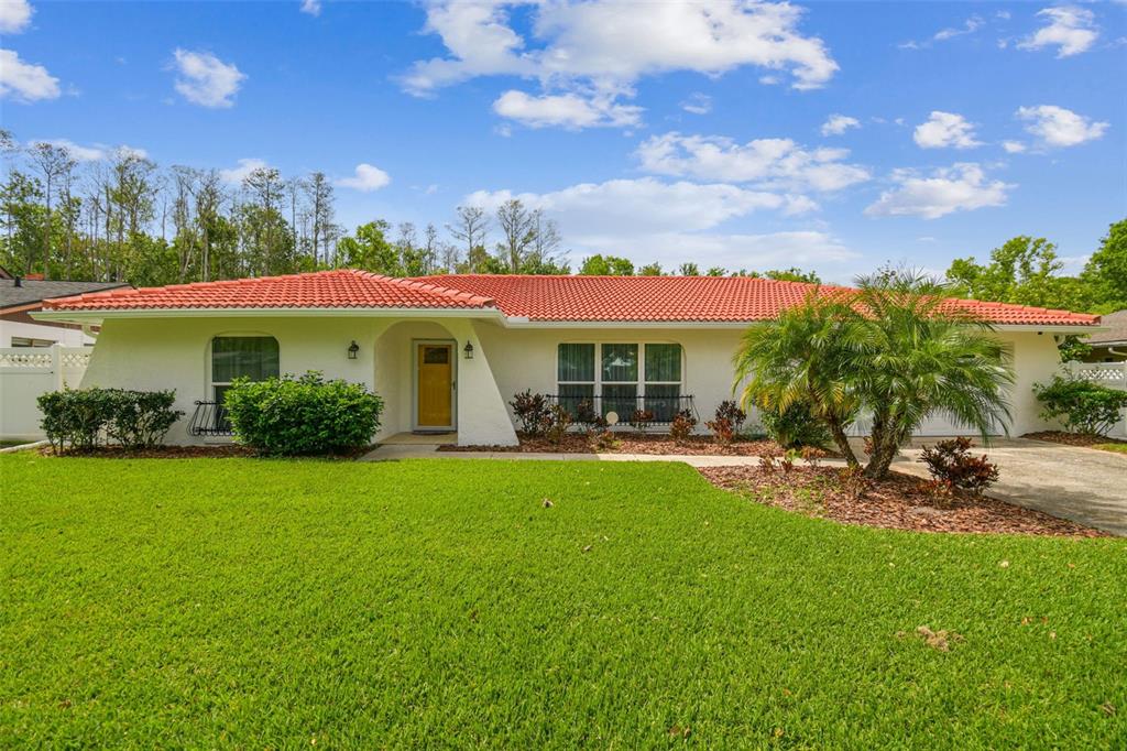 a view of a house with backyard sitting area and garden