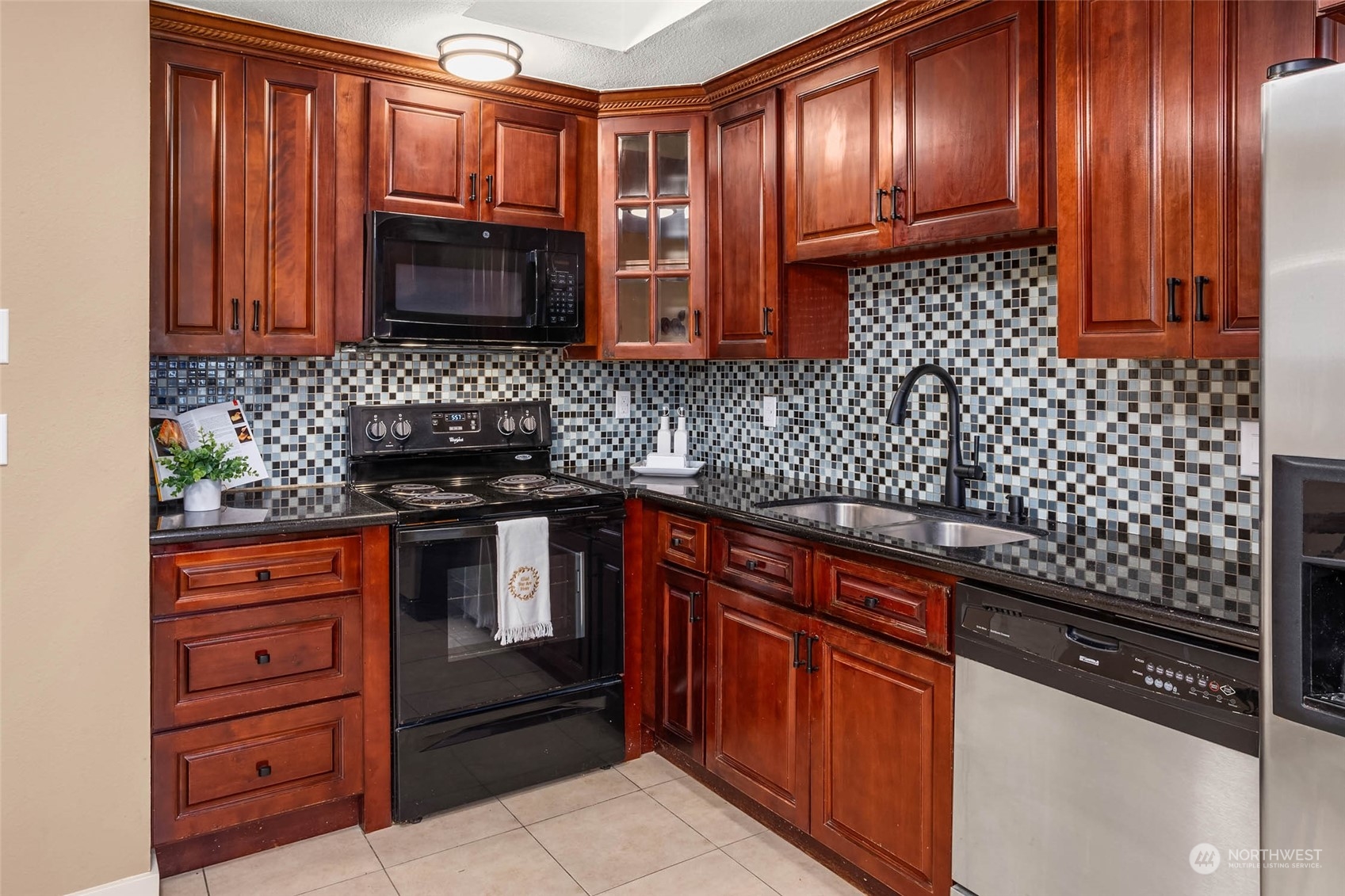 a kitchen with stainless steel appliances granite countertop wooden cabinets and a stove top oven