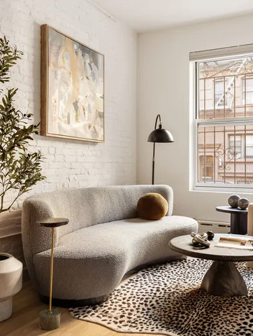 a dining room with furniture and potted plants