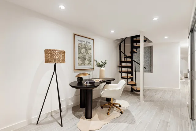 a view of a workspace with furniture and a couch