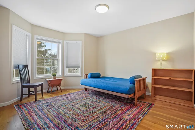 a bed room with a bed and windows