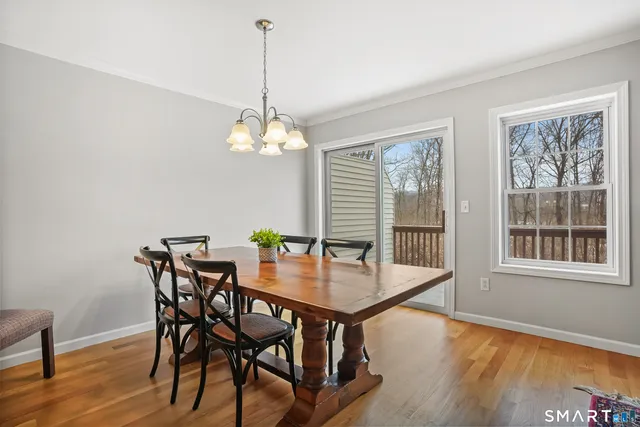 a view of a dining room with furniture wooden floor and a chandelier