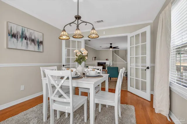 a kitchen with kitchen island granite countertop a table chairs stove and cabinets