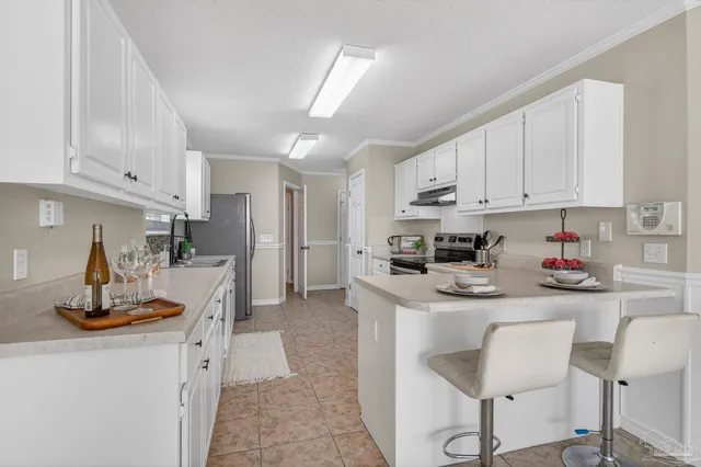 a kitchen with a refrigerator sink and cabinets