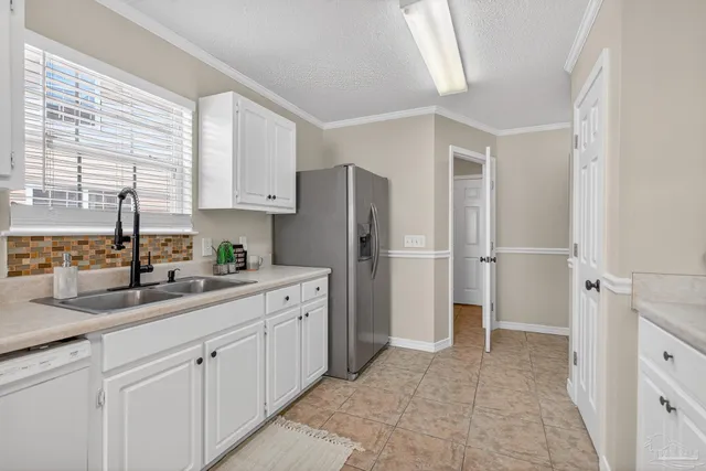 a kitchen with stainless steel appliances granite countertop a refrigerator sink and cabinets