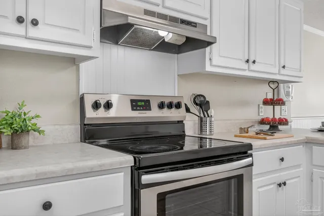 a view of a dining room with furniture and a chandelier