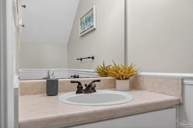 a view of a hallway with a livingroom and a bathroom