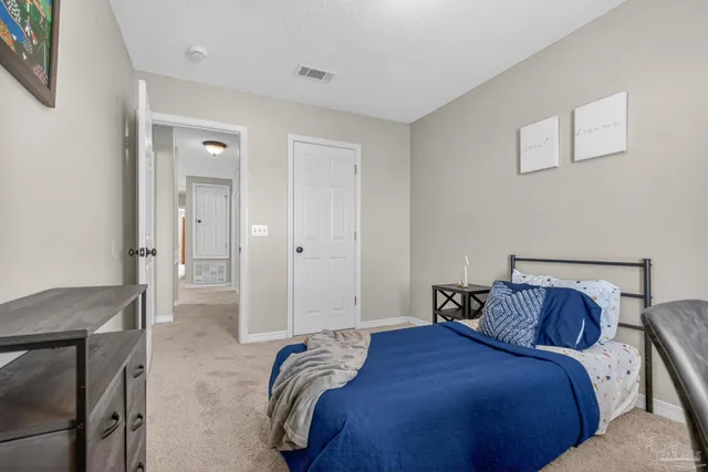 a bedroom with a bed and cabinets
