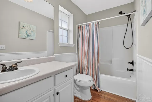 a bedroom with a bed and painting on the wall