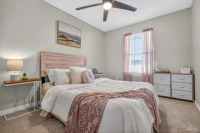 a view of a patio with couches chairs and wooden fence