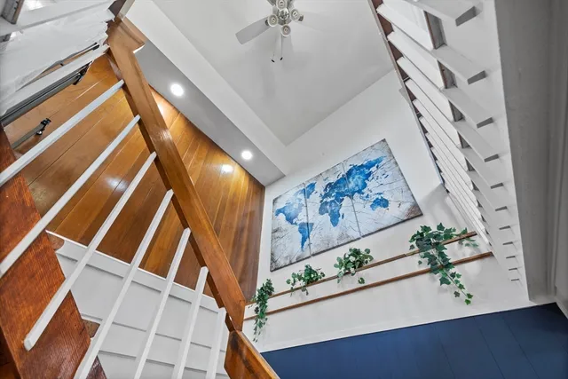 a kitchen with kitchen island granite countertop a refrigerator oven a sink and dishwasher