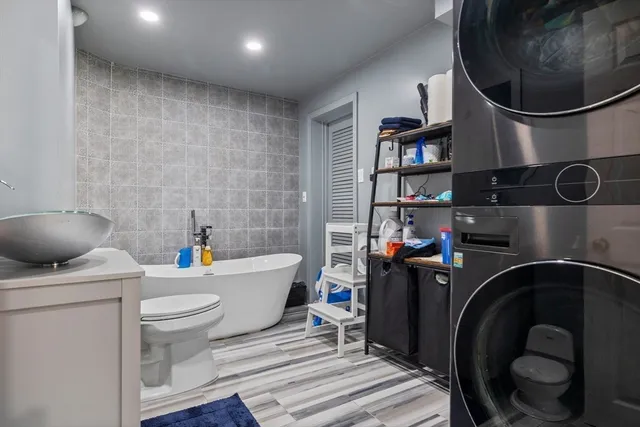 a white bath tub sitting next to a white toilet