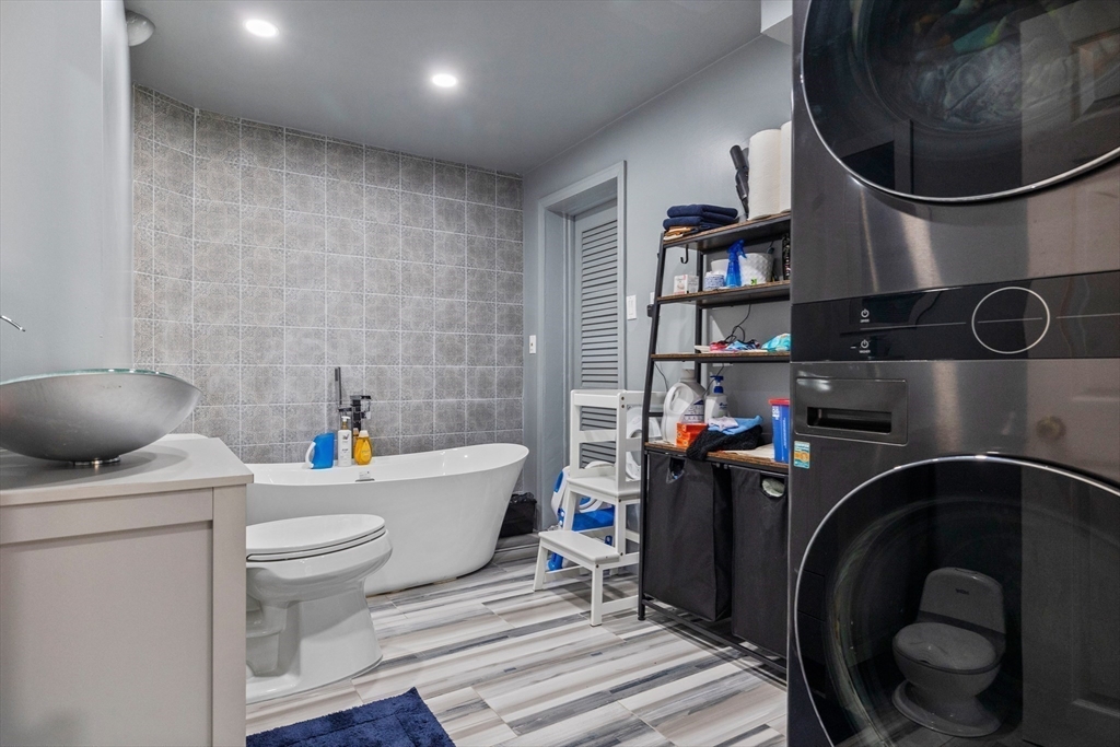 11 Patterson Road, Unit SF Lexington, MA 02421 - Photo 21 of 26 a bathroom with a toilet a sink and a mirror