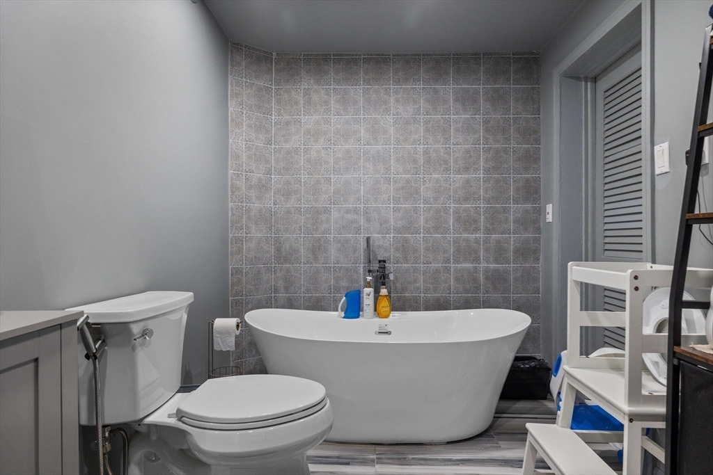 11 Patterson Road, Unit SF Lexington, MA 02421 - Photo 22 of 26 a white bath tub sitting next to a white toilet