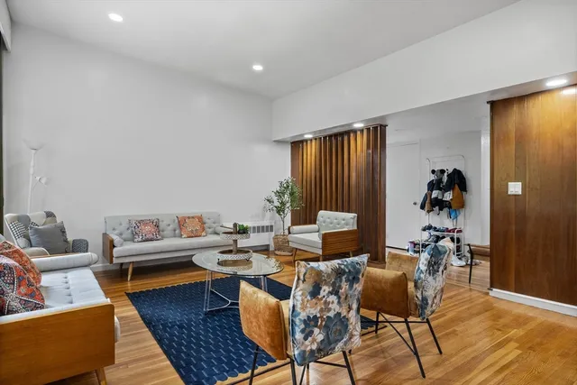 a living room with furniture and wooden floor