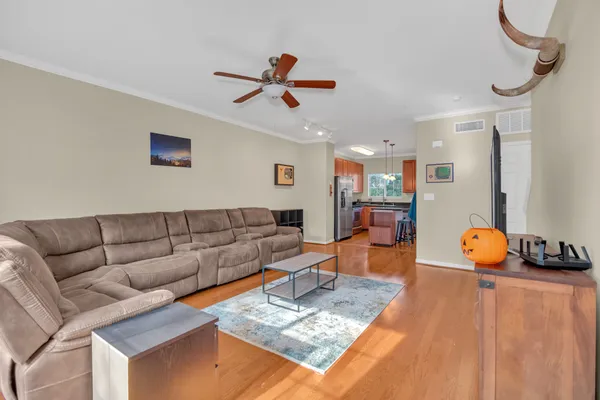 a living room with furniture and a wooden floor