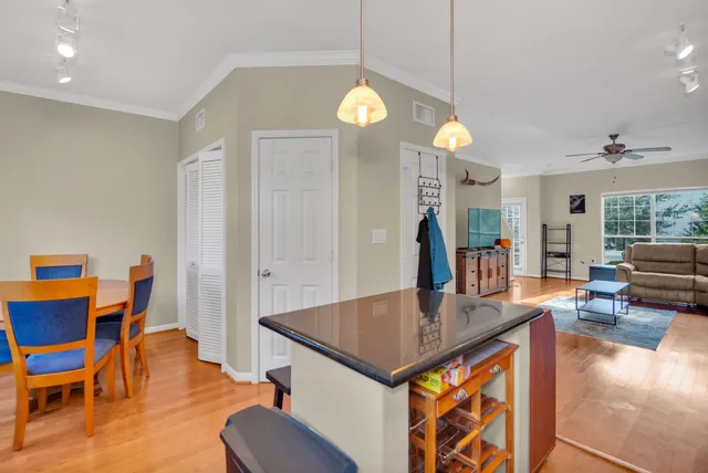 an open kitchen with dining table and chairs