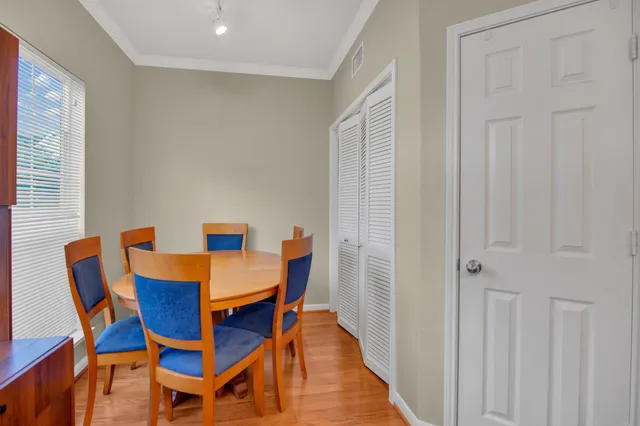 a view of a dining room with furniture and wooden floor
