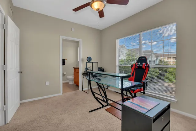 a view of a workspace with furniture and chandelier