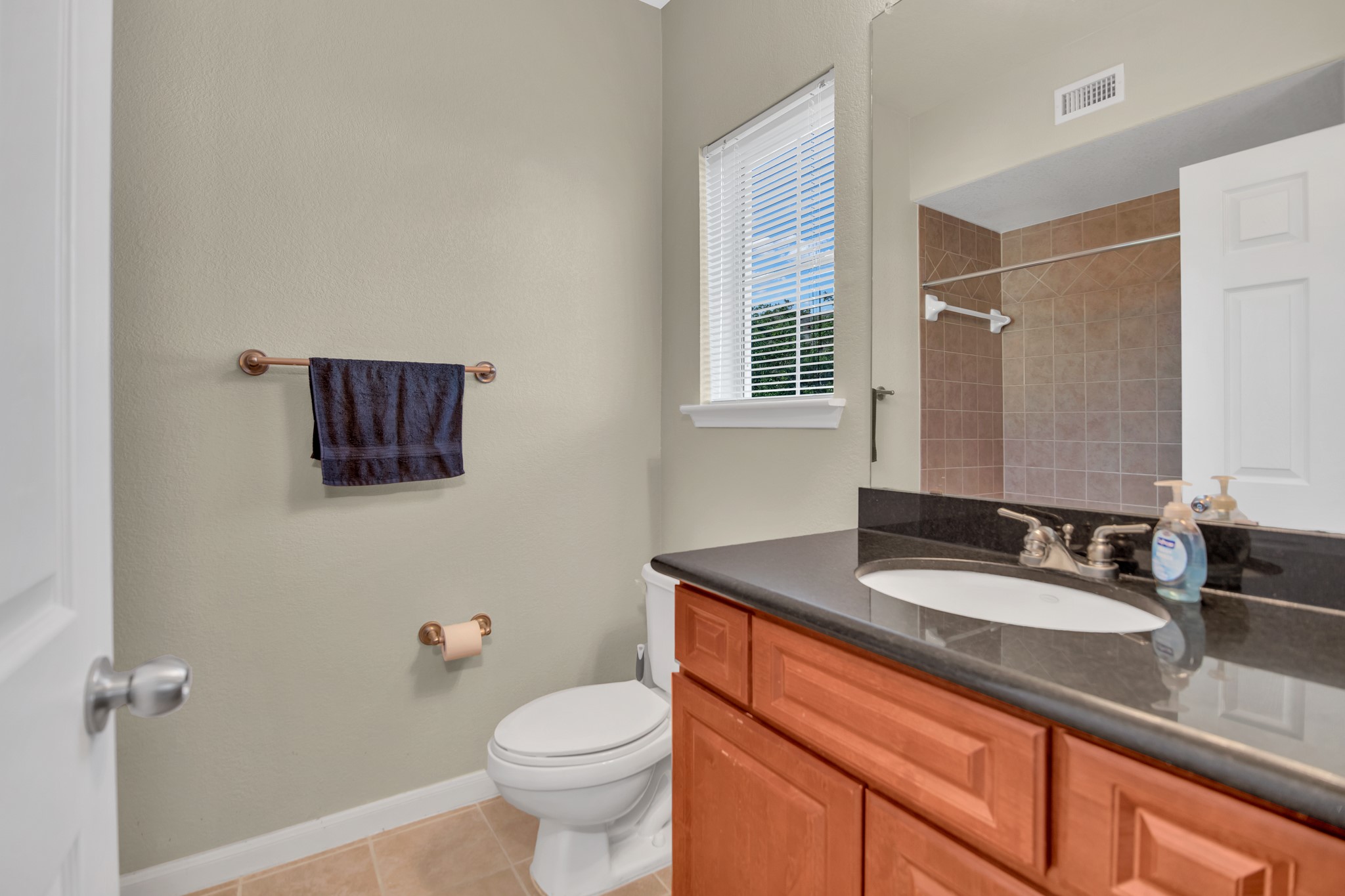 9200 Westheimer Road, Unit 1503 Houston, TX 77063 - Photo 20 of 37 a bathroom with a granite countertop sink a toilet and a mirror