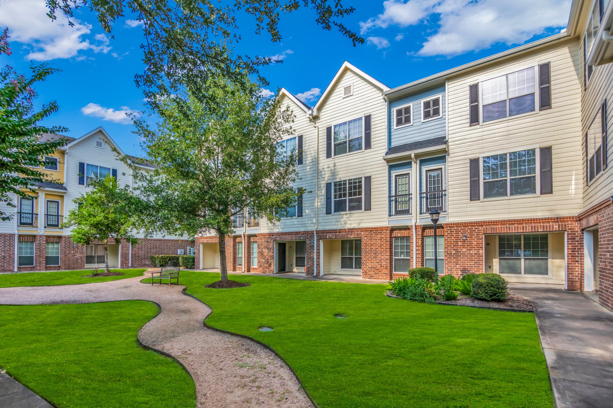 9200 Westheimer Road, Unit 1503 Houston, TX 77063 - Photo 2 of 37 a front view of a house with garden and trees