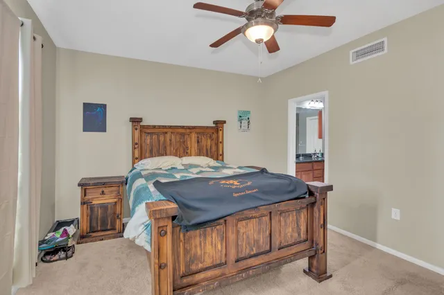 a bed sitting in a bedroom next to a window