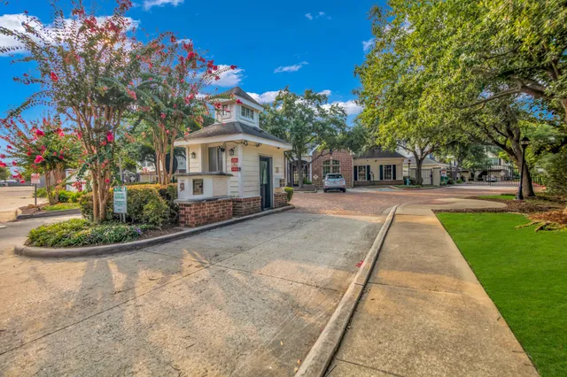 a front view of a house with a yard and potted plants