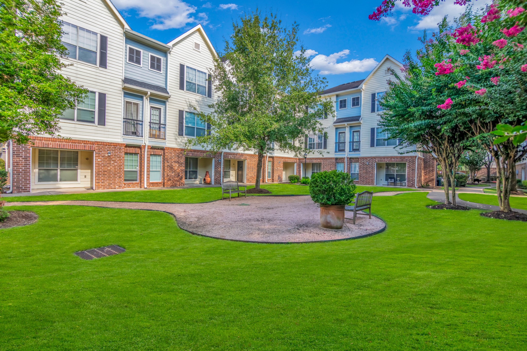 9200 Westheimer Road, Unit 1503 Houston, TX 77063 - Photo 4 of 37 a front view of a house with a yard and trees
