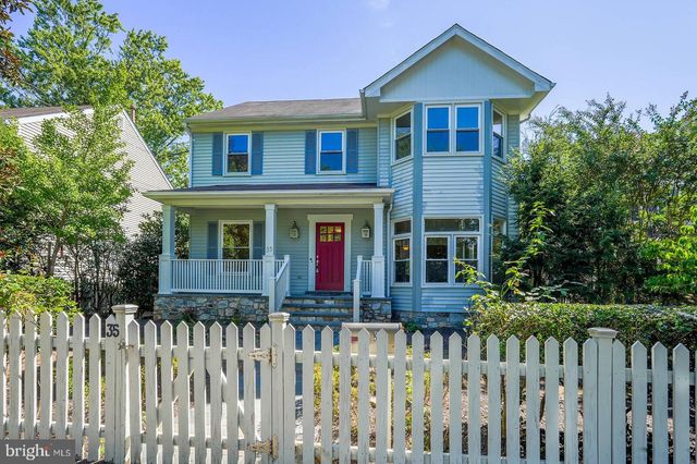 a front view of a house with wooden fence
