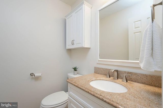 a view of a hallway with wooden floor and windows
