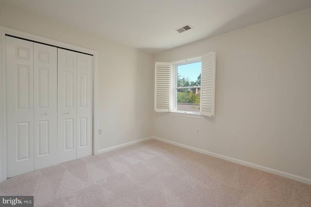 a bathroom with a toilet a sink a mirror a vanity and window