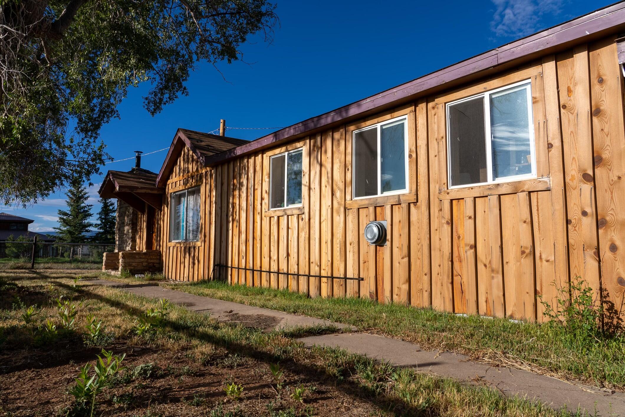 2122 County Road Norwood, CO 81423 - Photo 9 of 17 a front view of a house with a yard