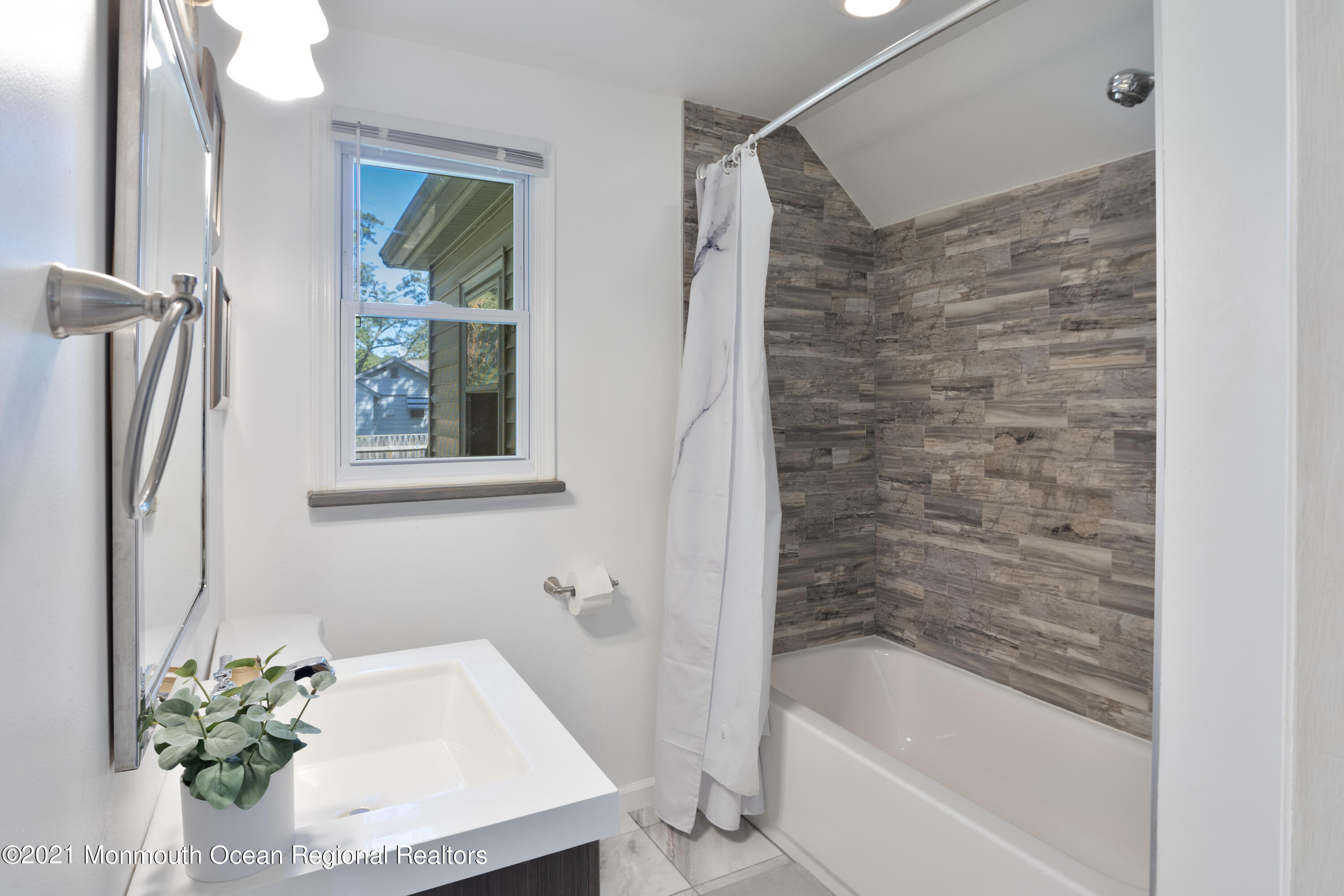 229 Lanes Pond Road Howell, NJ 07731 - Photo 13 of 25 a bathroom with a tub shower and a sink