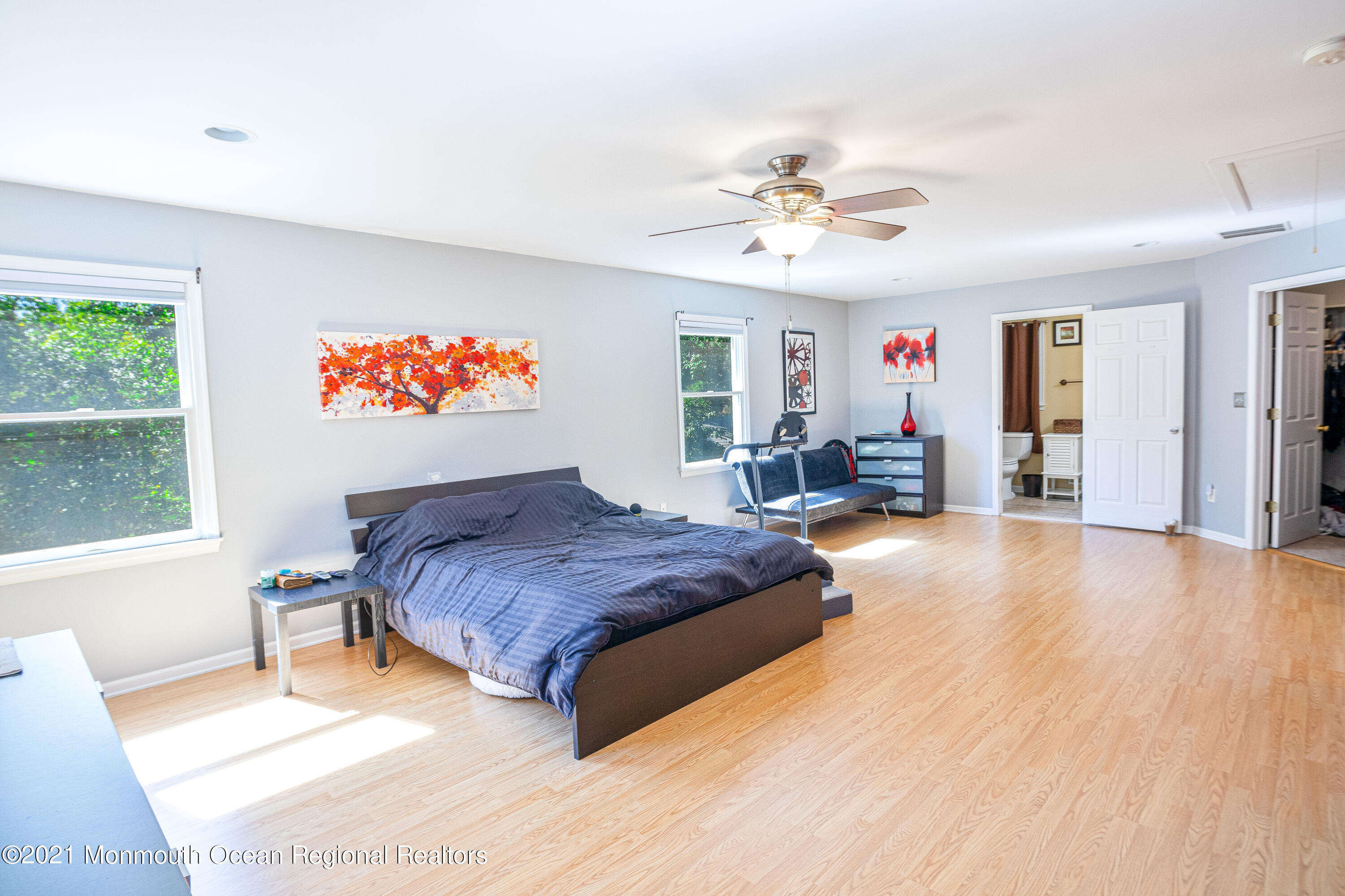 229 Lanes Pond Road Howell, NJ 07731 - Photo 21 of 25 a spacious bedroom with a bed and a chandelier