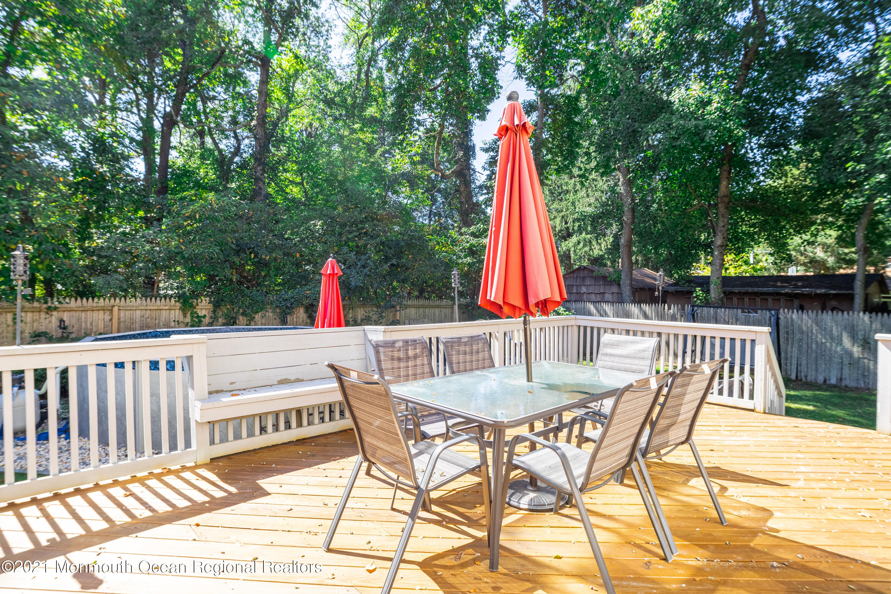 229 Lanes Pond Road Howell, NJ 07731 - Photo 4 of 25 a view of roof deck with table and chairs and wooden floor
