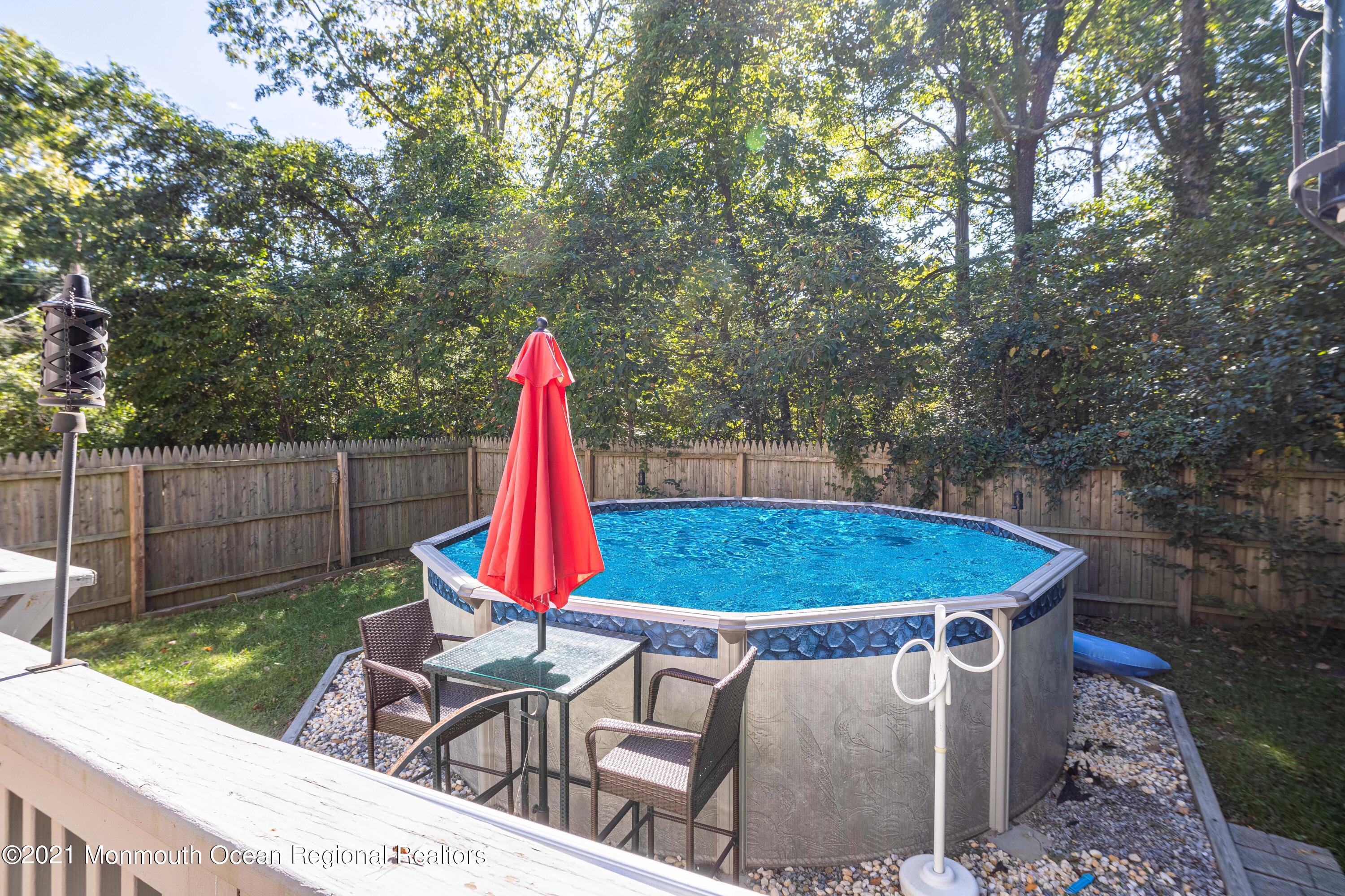 229 Lanes Pond Road Howell, NJ 07731 - Photo 7 of 25 a view of a backyard with furniture and wooden fence