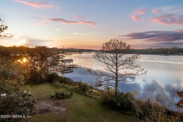 a view of a lake with houses in the back