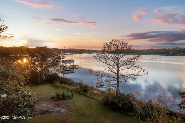 a view of a lake with houses in the back