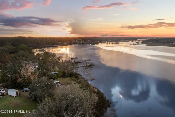a view of a lake with houses in the back