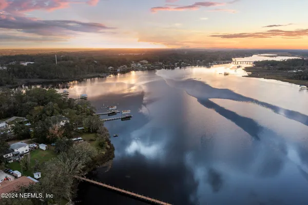 a view of a lake with houses in back