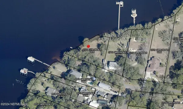 an aerial view of a houses with ocean view