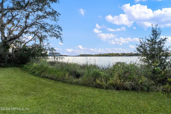 a view of a lake with a house in background